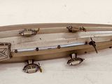 a silver model of an airplane on a white surface