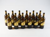 six bottles of wine are lined up in a row on a white surface