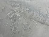 a white table cloth with a design on it