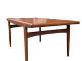 the table is made of teak and has a triangular shape