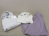 three pieces of clothing sitting on a bed next to each other