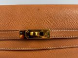 a brown leather purse with a gold clasp on it