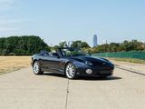 a black convertible car parked on the side of the road