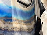 two dresses hanging on a rack in a store