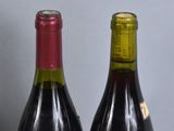 two bottles of wine sitting next to each other on a table