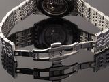 a close up of a wrist watch on a reflective surface