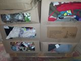 a cardboard box filled with clothes and other items
