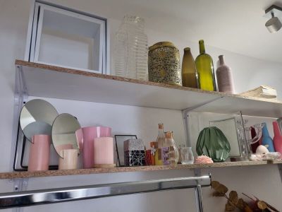 a shelf that has various bottles and vases on it