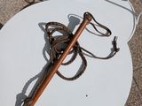 a white table with a cane and a rope on it