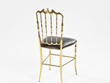 a gold chair with black leather seat on a white background