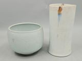 two vases sitting next to each other on a table