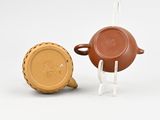 a brown teapot sitting next to a brown tea pot