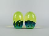 pair of green and blue glass salt and pepper shakers on a white surface