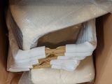 a cardboard box with a bunch of folded towels inside of it