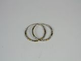 two silver and gold rings on a white surface
