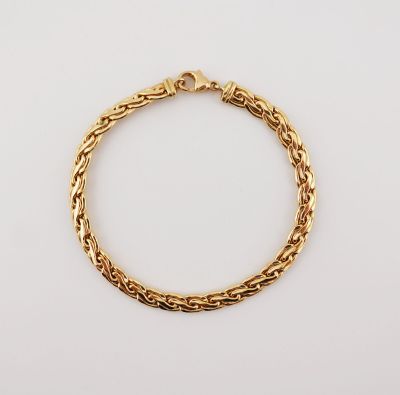 a gold chain bracelet with a clasp