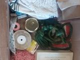a box full of sewing supplies sitting on the floor
