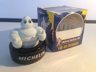 a toy car tire with a michel michel figurine on it