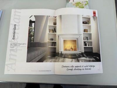 an open magazine with a picture of a fireplace in it