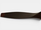 a knife on a white surface with a brown handle