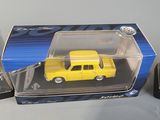 a yellow toy car in a box on a table