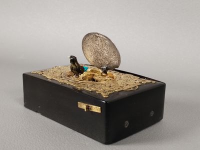 a coin sitting on top of a box with a coin in it