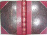 a red book that is open on a table