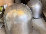 two metal pans sitting on top of a stove