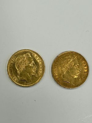 two gold coins are sitting next to each other on a white surface