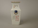 a white vase with a blue ring on it
