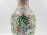a vase with a painting on it sitting on a table