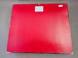 a close up of a red piece of paper on a table