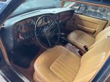 dashboard of a car with tan leather seats and steering wheel