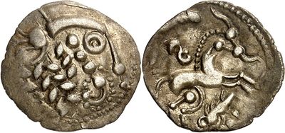 a silver coin with an image of a horse on it