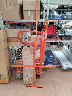 a stack of boxes on a cart in a warehouse