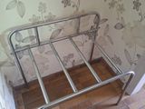 a metal bed frame in the corner of a room