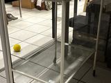 a glass shelf with a laptop on top of it