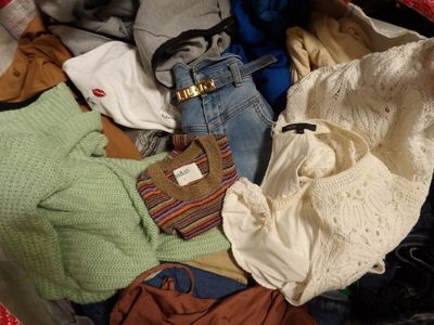 a suitcase full of clothes and a handbag full of clothes