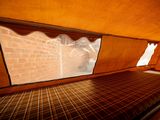 a bed in the inside of a tent with a window