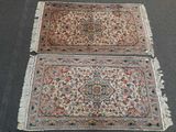 two rugs with fringes on them sitting on the floor