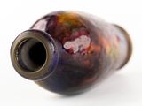 a close up of a vase on a white surface