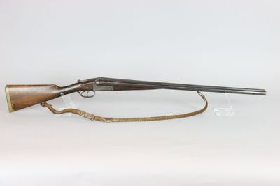 a rifle with a wooden barrel on a white background