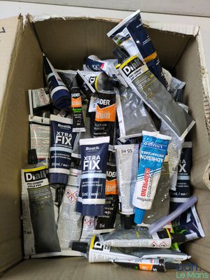 a cardboard box full of different types of paint