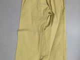 the bottom of a pair of yellow pants on a white surface