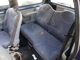 two seats in the back of a car that are dirty
