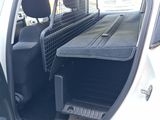 a white truck with a black bed in the back of it