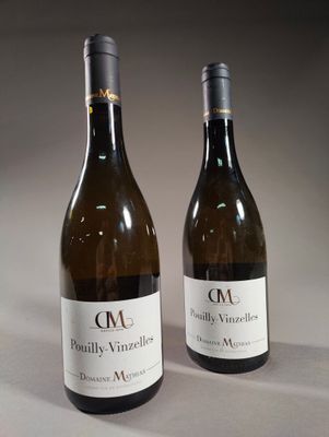 two bottles of wine sitting next to each other on a table