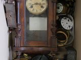 many different clocks in a box on the shelf