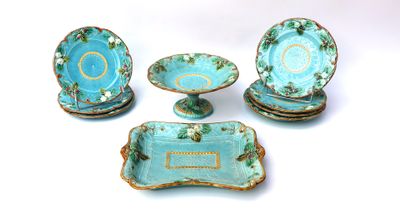 four pieces of blue and green pottery on display
