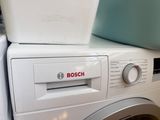 bosch washer and dryer stacked on top of each other in a laundry room